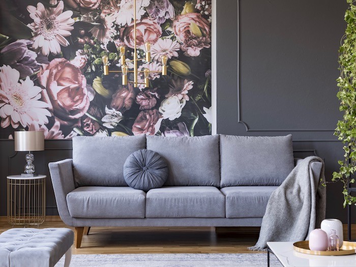 Large flower wall paper, grey paint and matching sofa